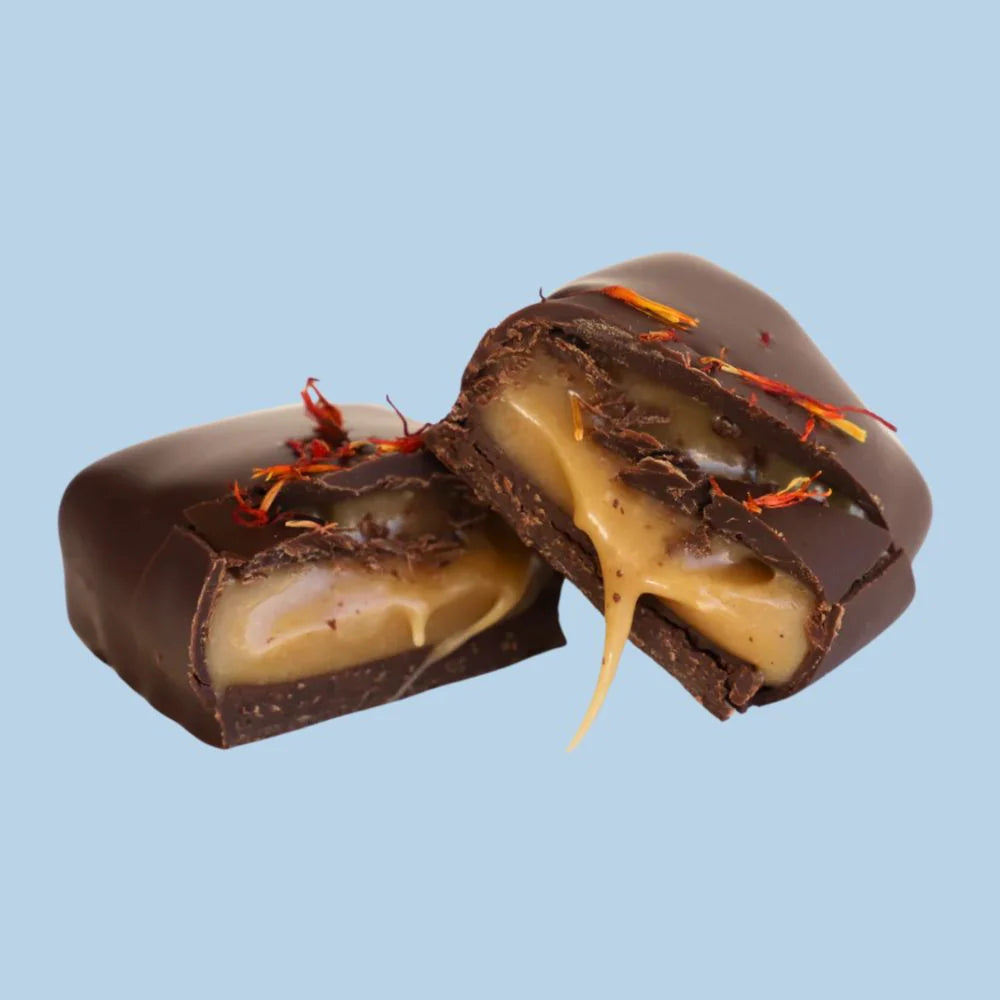 Close-up of Loco Love Classic Chewy Caramel bar showing gooey caramel centre inside 70% dark chocolate coating.