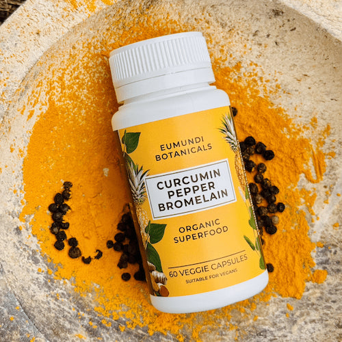Eumundi Medicine Man Curcumin Pepper Bromelain bottle photographed at angle – high absorption turmeric, piperine and bromelain herbal formula.