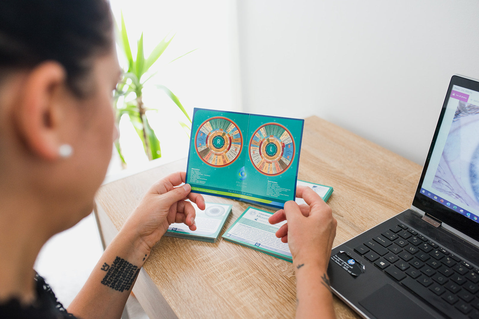 Diane Hackner reviewing an iridology chart.
