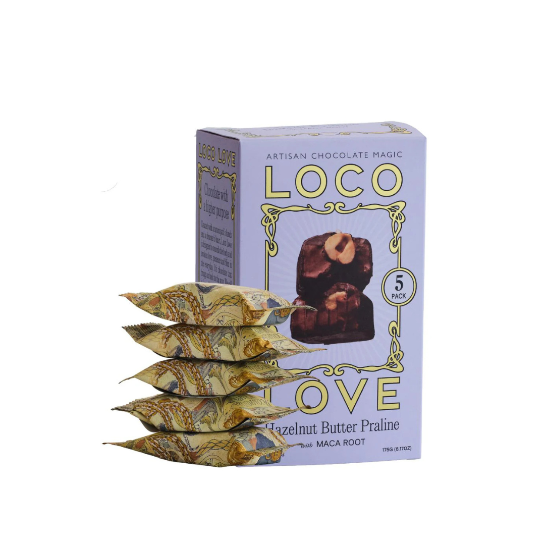 Loco Love Hazelnut Butter Praline bars stacked next to box – vegan, organic, refined-sugar-free indulgence.