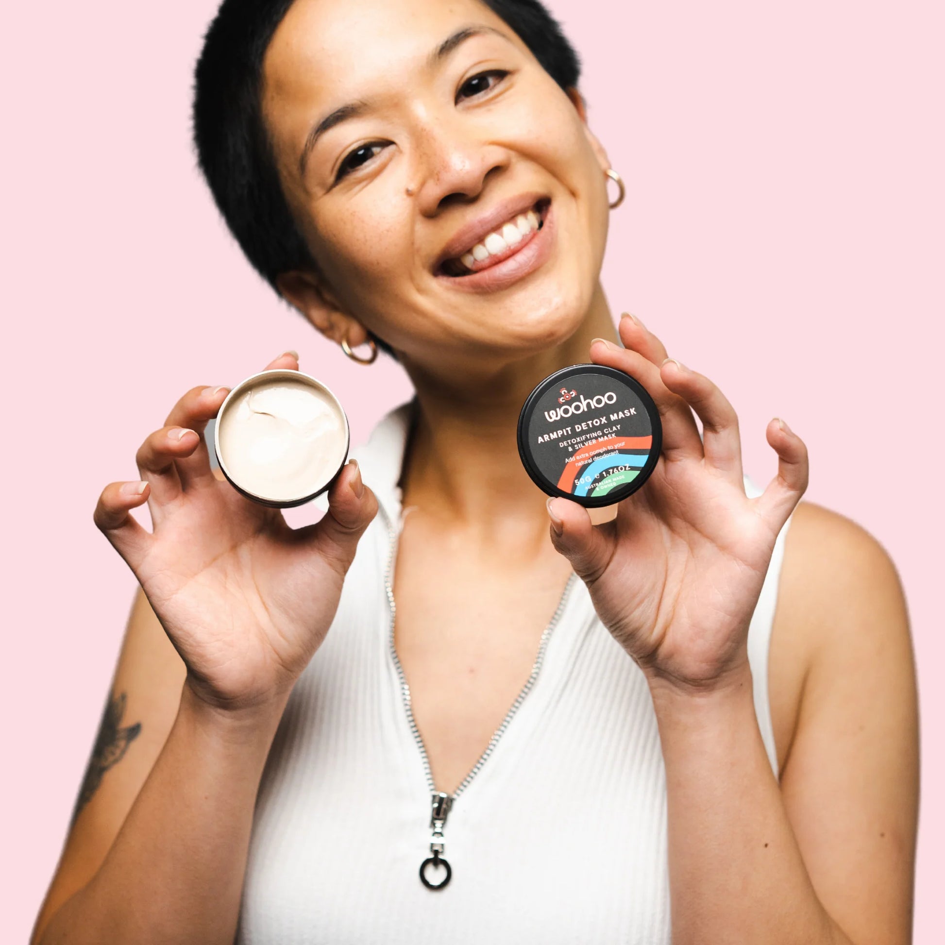 Woman holding Woohoo Body Armpit Detox Mask natural underarm detox clay mask showing creamy texture for natural deodorant transition and underarm odour support.