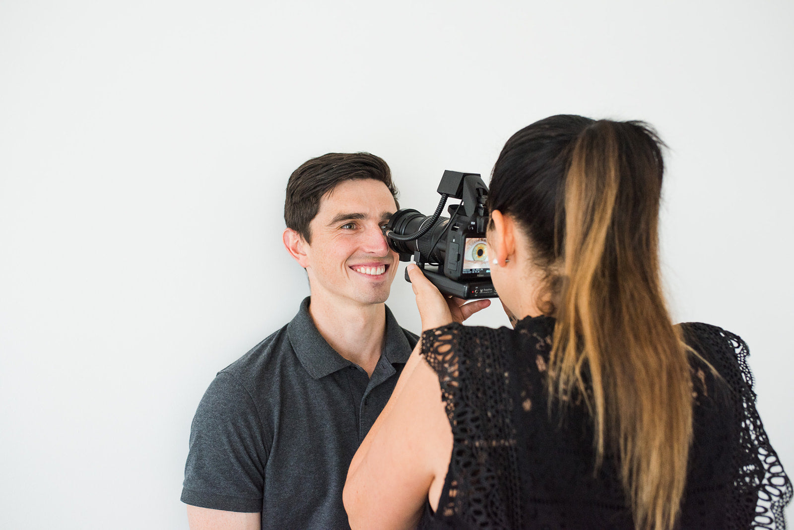 Practitioner Diane Hackner photographing a client’s eye in clinic – explore Renew Health Co. consultations.